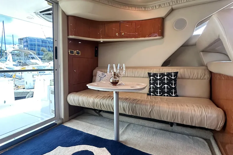 August Moon Yacht Photos Pics Interior of 2001 Sea Ray 400 Sedan Bridge with cozy seating and nautical decor.