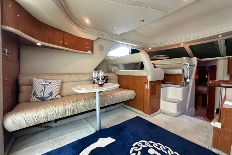 August Moon Yacht Photos Pics Luxurious interior of 2001 Sea Ray 400 Sedan Bridge yacht with plush seating and elegant decor.