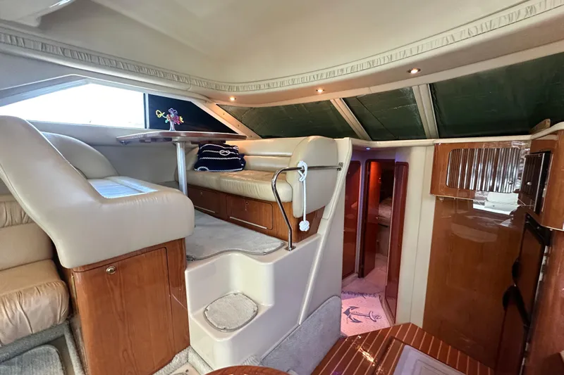 August Moon Yacht Photos Pics Interior of 2001 Sea Ray 400 Sedan Bridge yacht, featuring elegant seating and wooden finishes.
