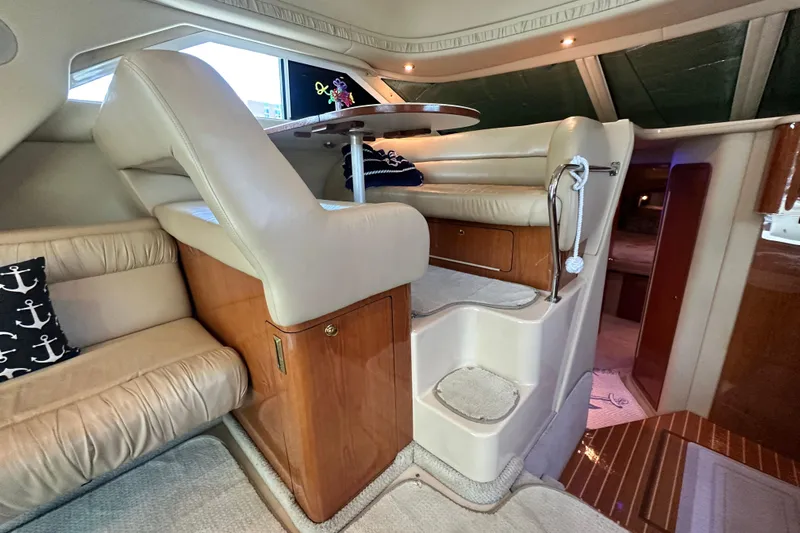 August Moon Yacht Photos Pics Luxurious interior of 2001 Sea Ray 400 Sedan Bridge with leather seating and wooden accents.