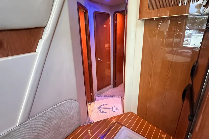 August Moon Yacht Photos Pics Interior hallway of 2001 Sea Ray 400 Sedan Bridge yacht with wooden finishes.