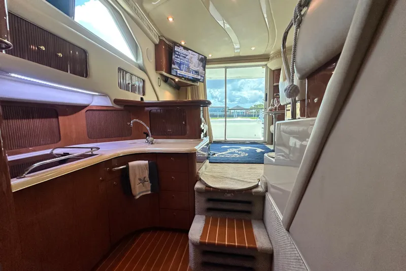 August Moon Yacht Photos Pics Luxurious interior of 2001 Sea Ray 400 Sedan Bridge yacht with modern kitchen and scenic view.