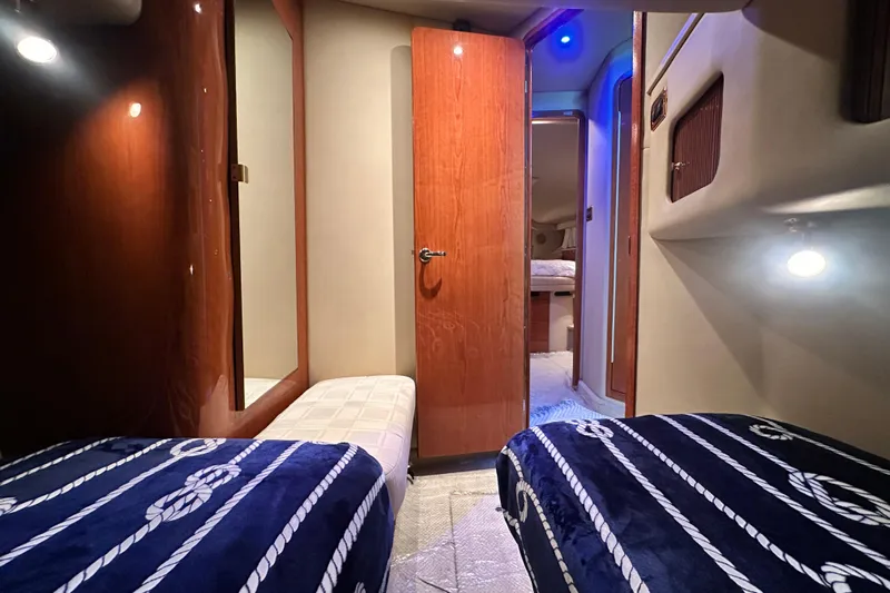August Moon Yacht Photos Pics Interior of 2001 Sea Ray 400 Sedan Bridge with twin beds and nautical decor.