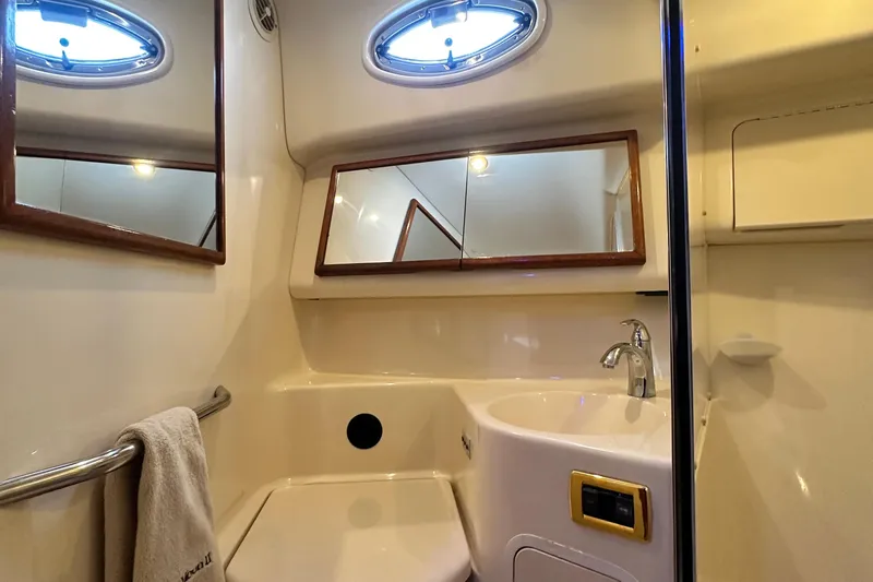 August Moon Yacht Photos Pics Bathroom interior of 2001 Sea Ray 400 Sedan Bridge yacht, featuring sink and mirror.