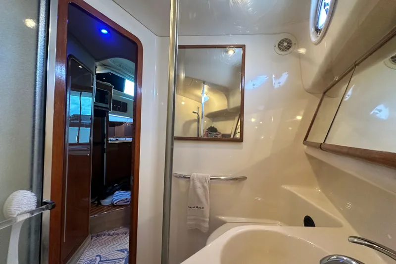 August Moon Yacht Photos Pics Interior of 2001 Sea Ray 400 Sedan Bridge yacht bathroom with mirror and sink.