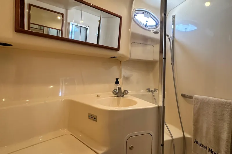 August Moon Yacht Photos Pics Bathroom interior of 2001 Sea Ray 400 Sedan Bridge yacht, featuring sink and shower.
