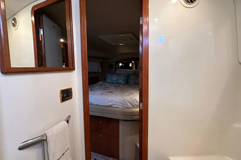 August Moon Yacht Photos Pics Interior cabin view of 2001 Sea Ray 400 Sedan Bridge yacht, featuring a cozy bedroom.