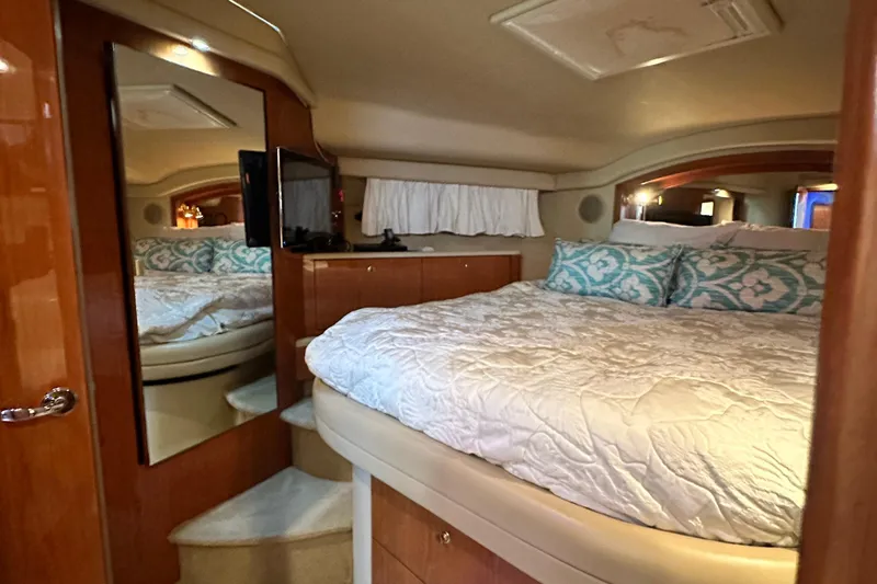 August Moon Yacht Photos Pics Luxurious 2001 Sea Ray 400 Sedan Bridge bedroom with cozy bedding and elegant wood finishes.