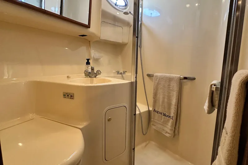 August Moon Yacht Photos Pics Bathroom interior of 2001 Sea Ray 400 Sedan Bridge yacht, featuring shower and sink.