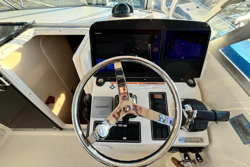  Yacht Photos Pics Steering console of a 2006 Pursuit 3070 Offshore boat with navigation equipment.