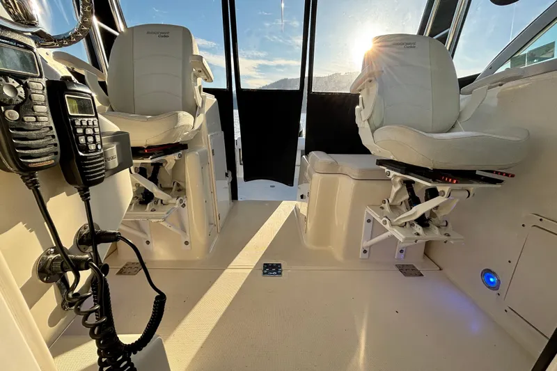  Yacht Photos Pics Interior of 2006 Pursuit 3070 Offshore boat with captain chairs and communication equipment.