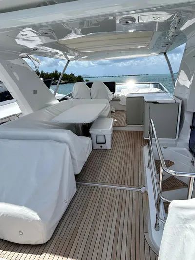  Yacht Photos Pics 2023 Azimut Fly 60 yacht deck with seating, table, and ocean view.