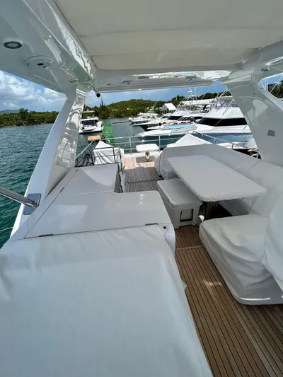  Yacht Photos Pics 2023 Azimut Fly 60 yacht deck with seating, docked in a marina.
