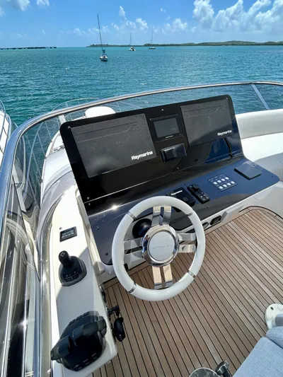  Yacht Photos Pics 2023 Azimut Fly 60 yacht helm with modern controls, on a serene ocean backdrop.