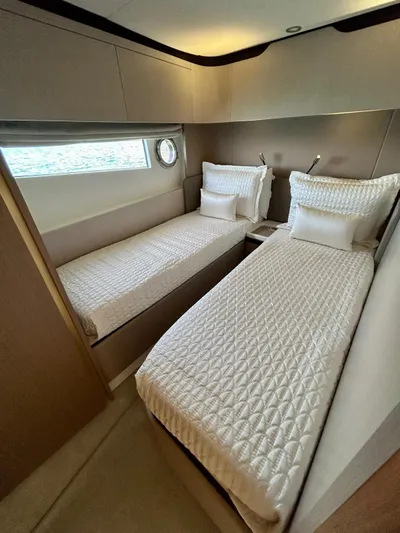  Yacht Photos Pics 2023 Azimut Fly 60 yacht cabin with twin beds, modern design, and elegant bedding.