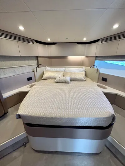  Yacht Photos Pics Luxurious bedroom interior of 2023 Azimut Fly 60 yacht with modern design and cozy bedding.