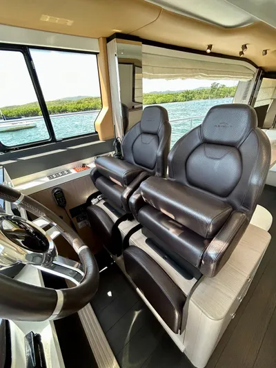  Yacht Photos Pics 2023 Azimut Fly 60 yacht interior with luxurious leather seating and modern steering wheel.