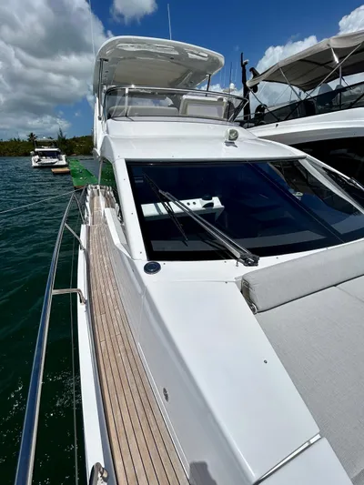  Yacht Photos Pics 2023 Azimut Fly 60 yacht with sleek design, docked on a sunny day.