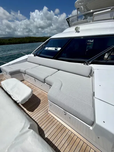  Yacht Photos Pics 2023 Azimut Fly 60 yacht with spacious deck seating under a cloudy sky.