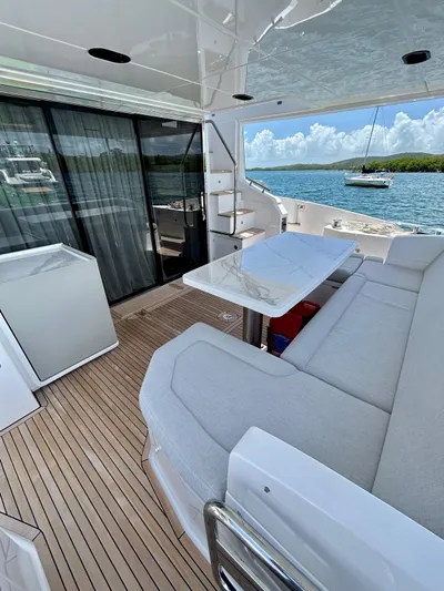  Yacht Photos Pics 2023 Azimut Fly 60 yacht deck with seating, table, and ocean view.