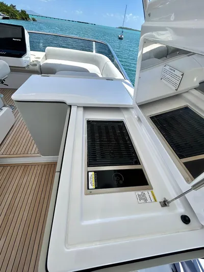  Yacht Photos Pics 2023 Azimut Fly 60 yacht deck with grill, overlooking serene blue waters.