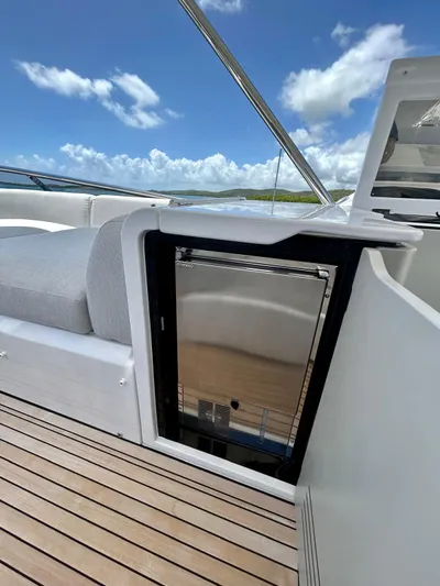  Yacht Photos Pics 2023 Azimut Fly 60 yacht deck with built-in mini fridge and seating.