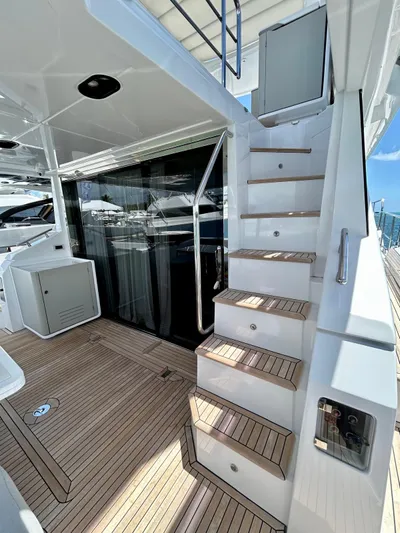  Yacht Photos Pics 2023 Azimut Fly 60 yacht with sleek wooden deck and modern staircase design.