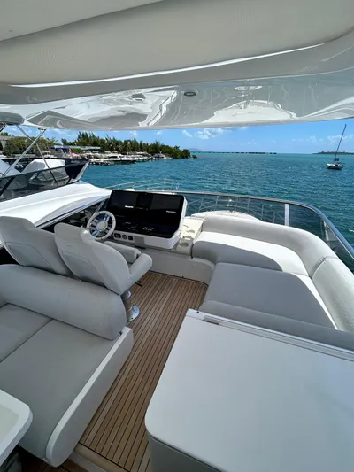  Yacht Photos Pics 2023 Azimut Fly 60 yacht with luxurious deck, overlooking serene ocean and distant shoreline.