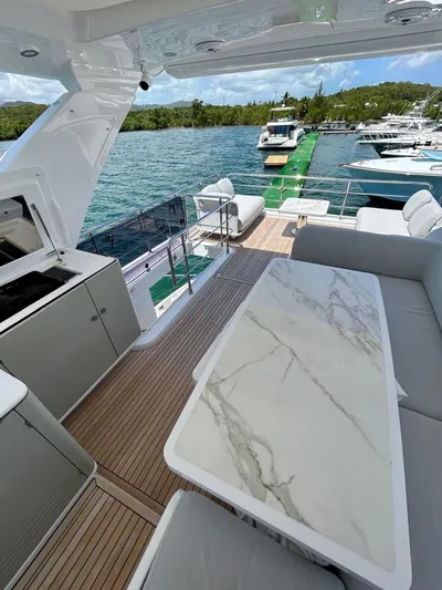  Yacht Photos Pics Azimut Fly 60 yacht deck with elegant seating and marble table, 2023 model.