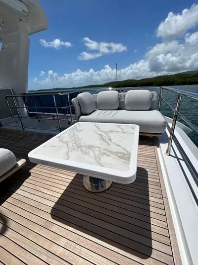  Yacht Photos Pics Luxury deck of 2023 Azimut Fly 60 yacht with marble table and plush seating.