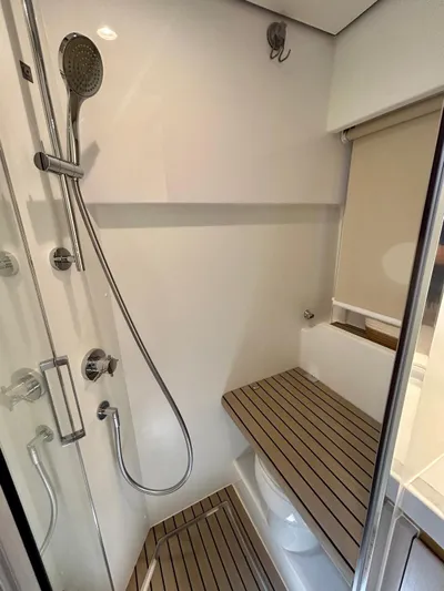  Yacht Photos Pics Luxurious 2023 Azimut Fly 60 yacht bathroom with modern shower and wooden accents.