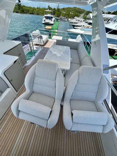  Yacht Photos Pics 2023 Azimut Fly 60 yacht deck with plush seating and scenic marina view.