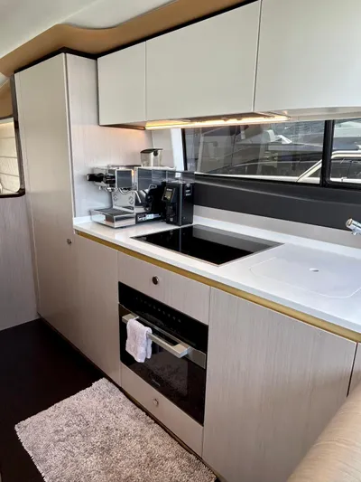  Yacht Photos Pics Modern kitchen in 2023 Azimut Fly 60 yacht with sleek cabinetry and appliances.