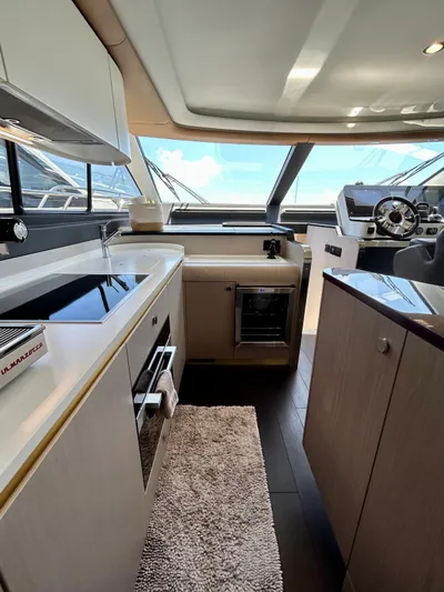  Yacht Photos Pics Interior of 2023 Azimut Fly 60 yacht, featuring modern kitchen and helm station.