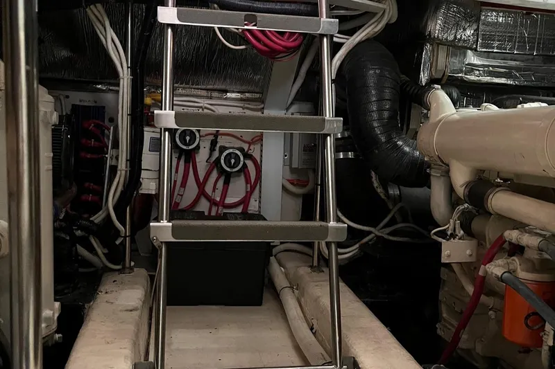 Ware II Go Yacht Photos Pics Engine room of 2002 Carver 466 Motor Yacht with ladder and mechanical components.