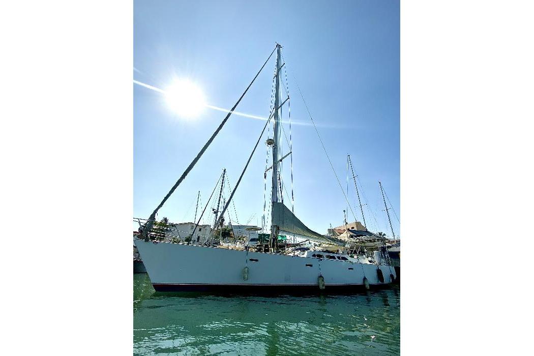 Custom Lidgard 60 Racing Cruiser, 2001, docked under clear blue sky.