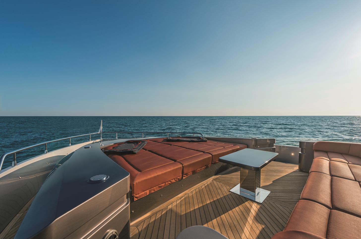 Luxurious AB 80 yacht deck with seating, ocean view, and clear sky, 2025 model.