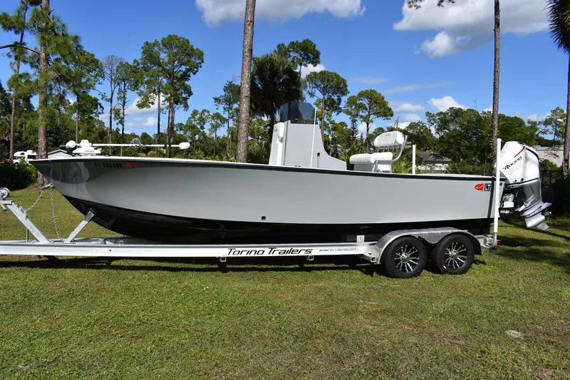  Yacht Photos Pics 2025 Latitude Tournament Boats 25 on trailer, parked on grass with trees in background.