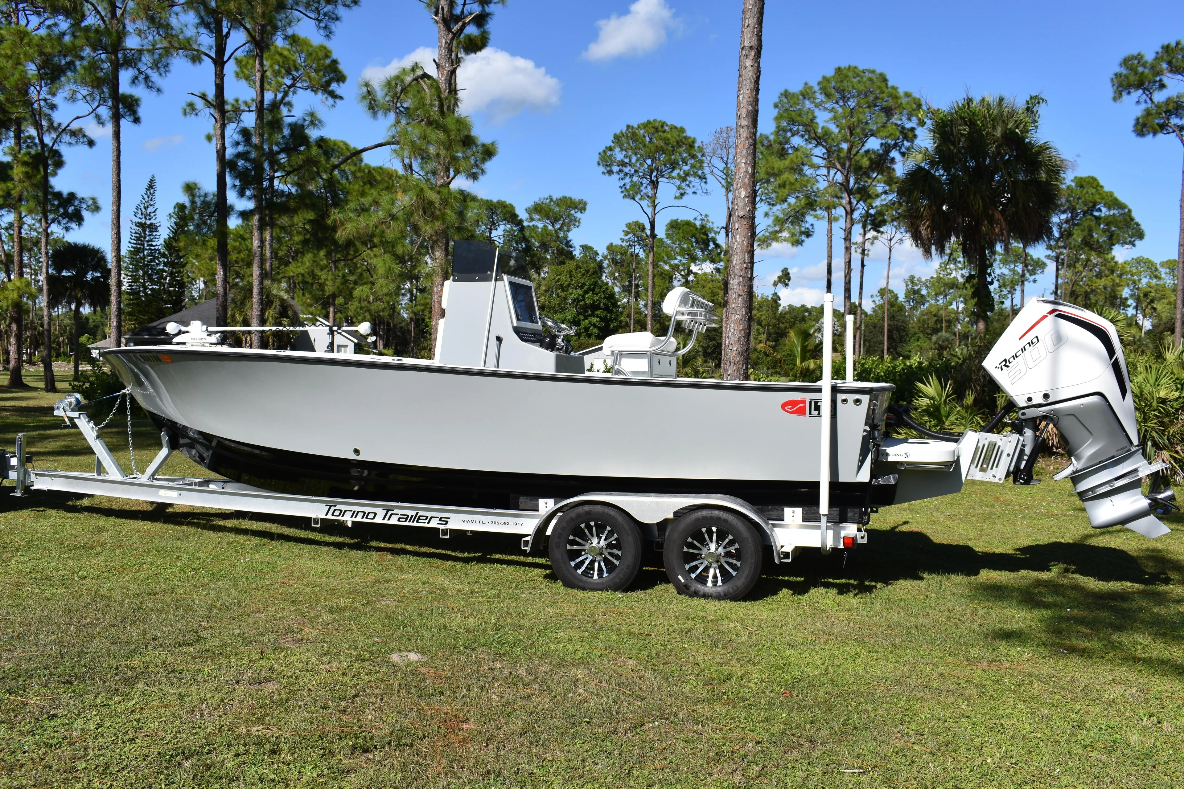  Yacht Photos Pics 2025 Latitude Tournament Boats 25 on trailer, parked in a scenic outdoor setting.