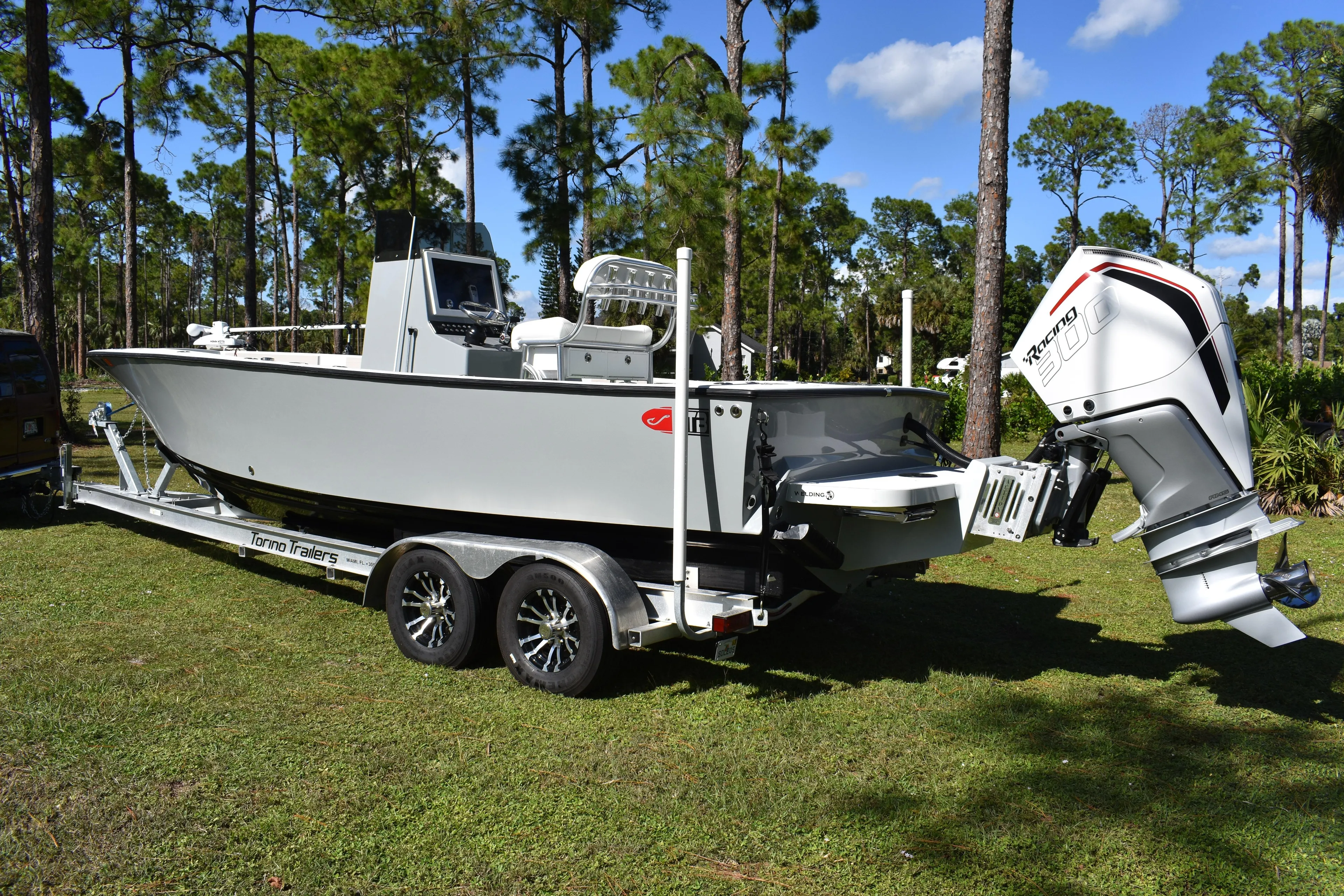 Yacht Photos Pics 2025 Latitude Tournament Boats 25 on trailer, parked in a scenic wooded area.