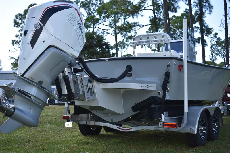  Yacht Photos Pics 2025 Latitude Tournament Boats 25 with powerful outboard motor, parked on a trailer.