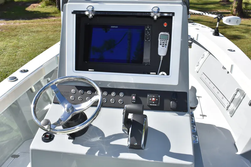  Yacht Photos Pics 2025 Latitude Tournament Boats 25 dashboard with steering wheel and navigation system.