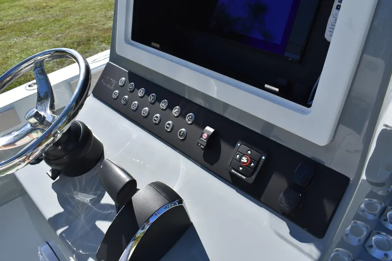  Yacht Photos Pics Control panel of 2025 Latitude Tournament Boats 25, featuring steering wheel and electronic controls.