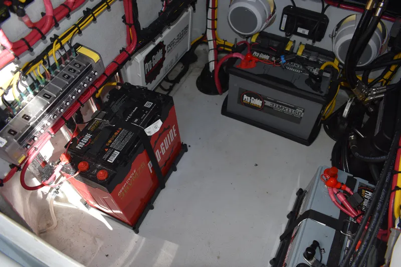  Yacht Photos Pics Battery compartment of 2025 Latitude Tournament Boats 25, featuring Pro-Guide batteries and wiring.