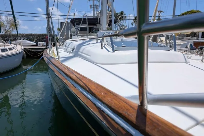 Must Love Dogs Yacht Photos Pics 1996 Beneteau 50 sailboat docked, showcasing sleek deck and polished woodwork.