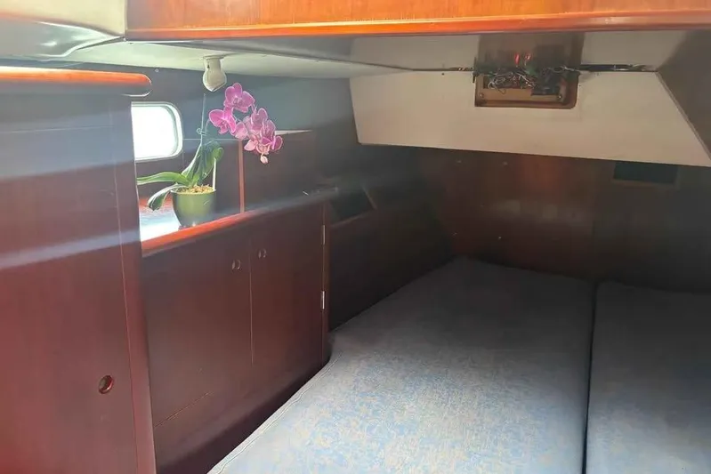 Must Love Dogs Yacht Photos Pics Cozy cabin interior of a 1996 Beneteau 50 sailboat with orchid decoration.