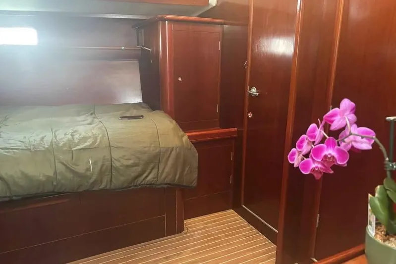 Must Love Dogs Yacht Photos Pics Cozy cabin interior of 1996 Beneteau 50 yacht with wooden finish and orchid decor.