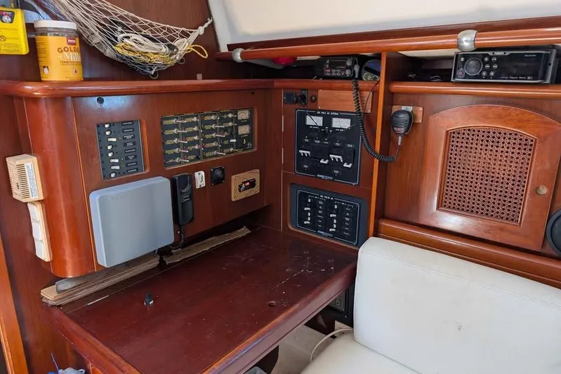 Must Love Dogs Yacht Photos Pics Navigation station of a 1996 Beneteau 50 yacht with control panels and equipment.