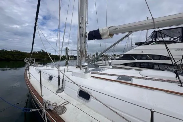 Must Love Dogs Yacht Photos Pics Sailing yacht Beneteau 50, 1996 model, docked with overcast sky.