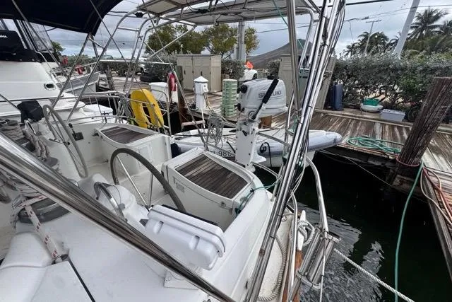 Must Love Dogs Yacht Photos Pics Cockpit view of a 1996 Beneteau 50 sailboat docked at a marina.